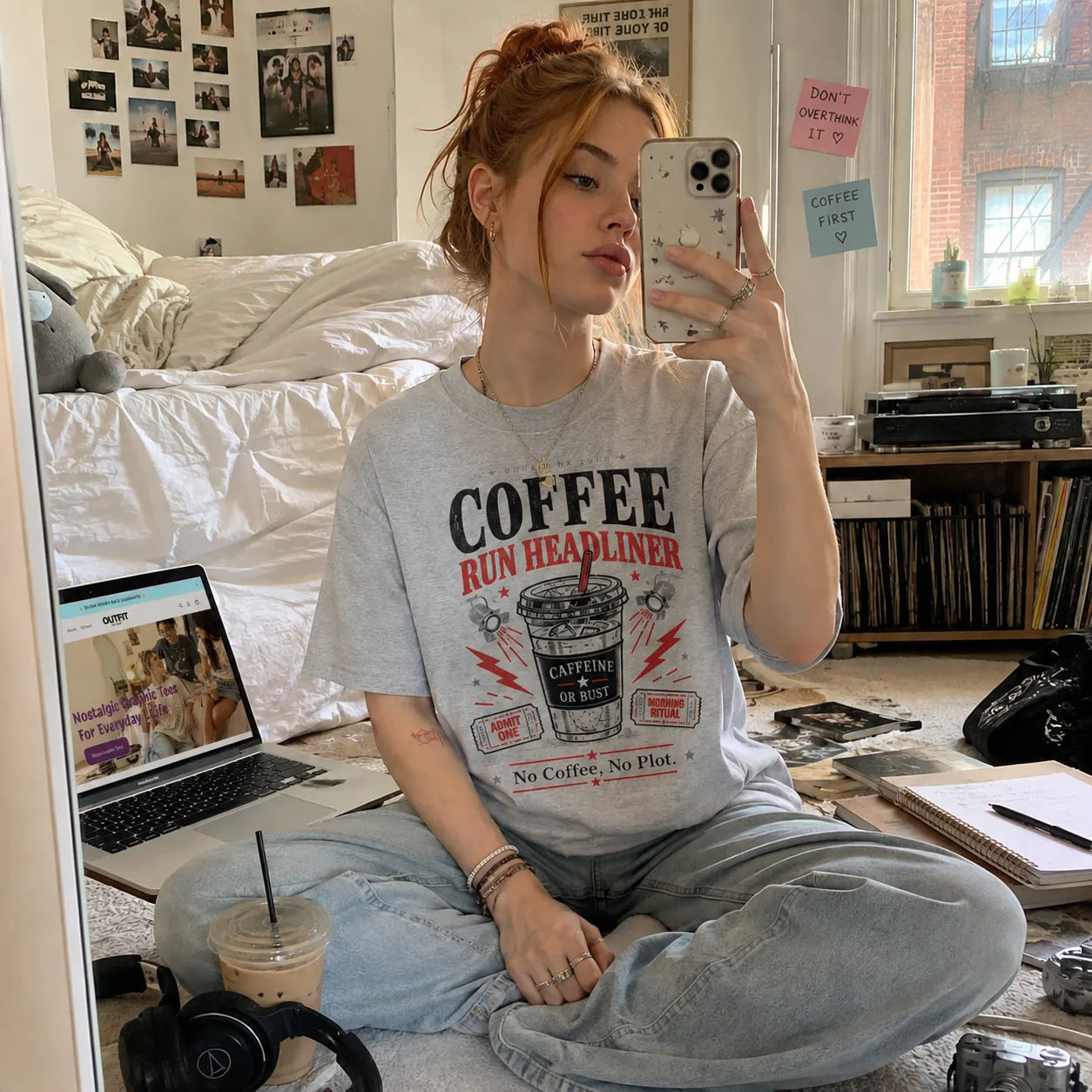 Girl taking a mirror selfie in a bedroom while wearing a coffee-themed graphic T-shirt - Outfit On Tour